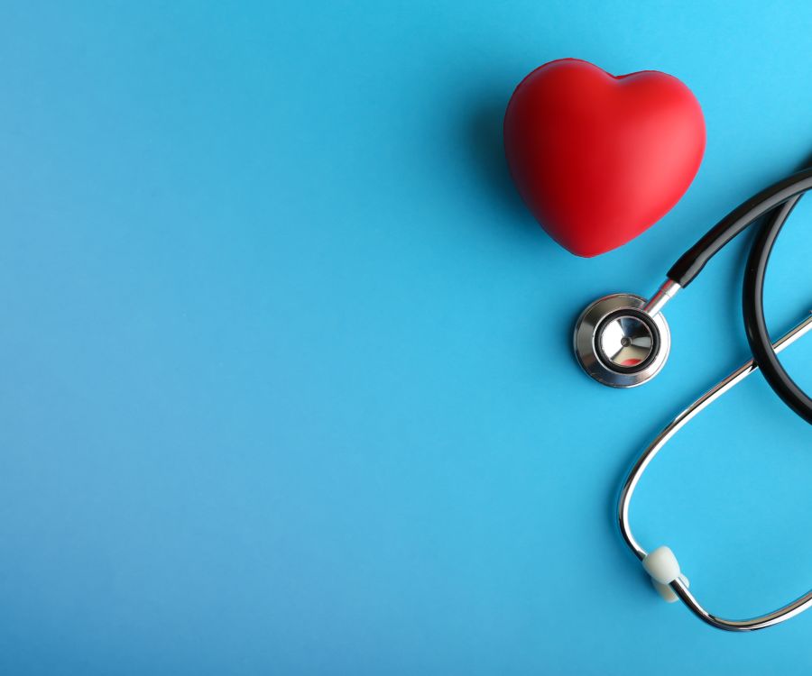 Image of stethoscope and heart icon atop a blue table