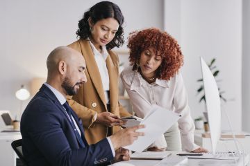 three business people looking at a document