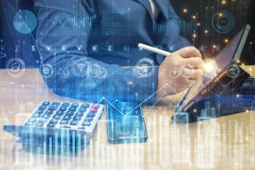 Payroll - Person using tablet with stylus near calculator, overlaid with digital financial and data graphics.